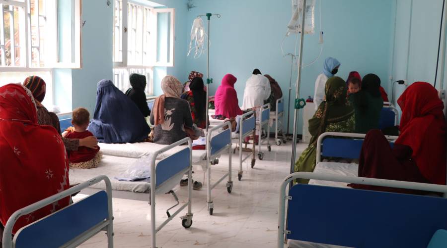 A long-view image of a measles ward in a hospital, showing multiple patients receiving treatment amid a growing outbreak.