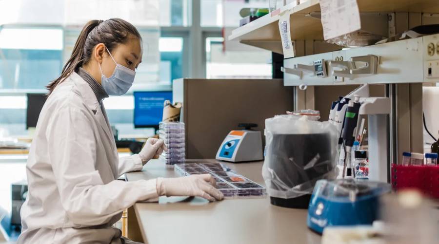 A scientist in a Canadian research laboratory working on an advanced diagnostic test for high-risk childhood brain tumors, improving medulloblastoma treatment and patient outcomes.