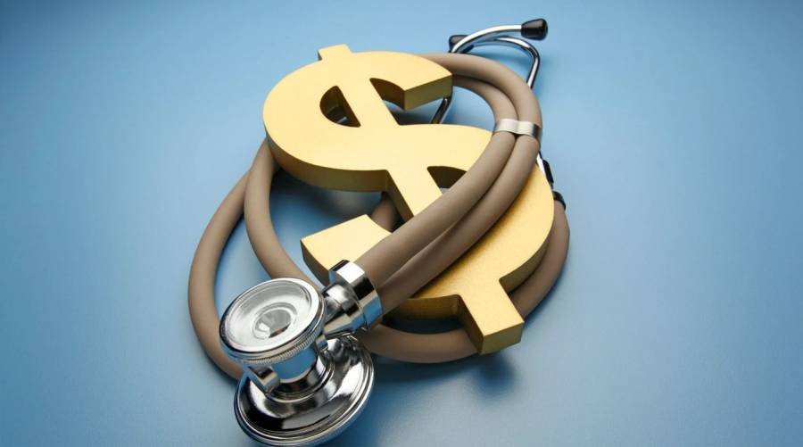 Stethoscope wrapped around a golden dollar sign on a blue background, symbolizing healthcare costs and economic impact in the United States.