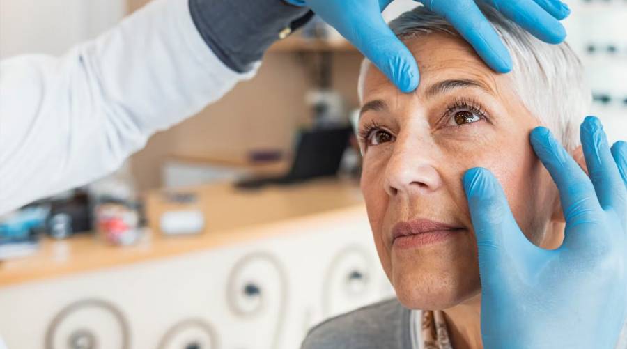 Doctor examining a woman's eye in clinic before cataract surgery