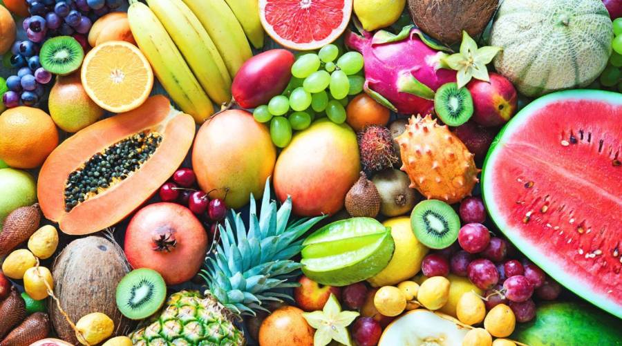 Person with diabetes enjoying a bowl of fresh fruit safely as part of a balanced diet