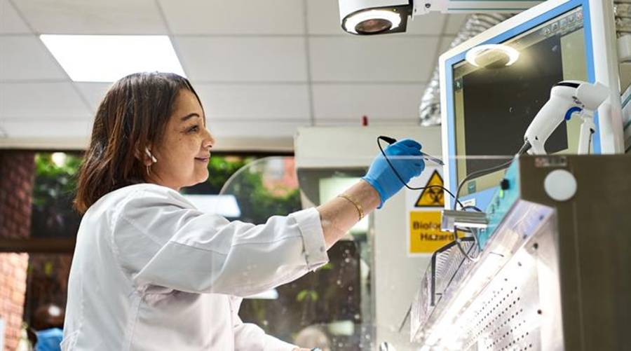 Aga Khan University researcher in a lab working on data-driven healthcare innovation for Afya Gemma platform.