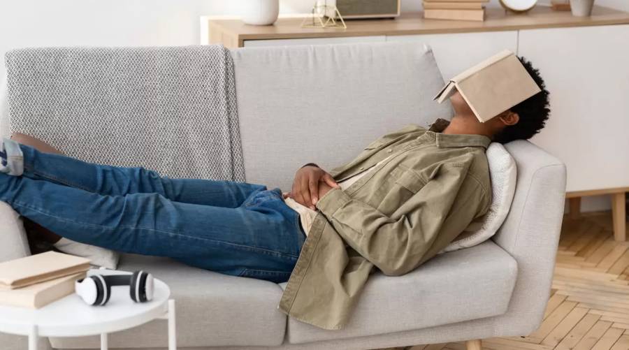 Older adult taking a daytime nap on the couch, highlighting risks of irregular nap patterns