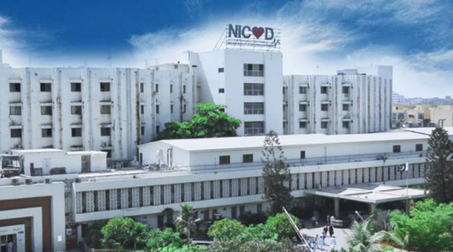Long shot of NICVD Karachi building exterior under clear sky.