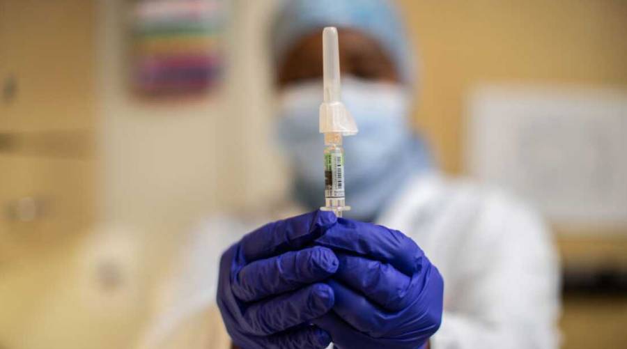 Healthcare worker prepares flu vaccine containing thimerosal preservative