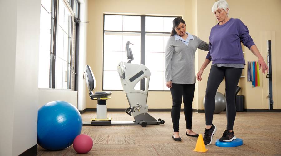 Senior woman walking safely at home after using fall prevention strategies
