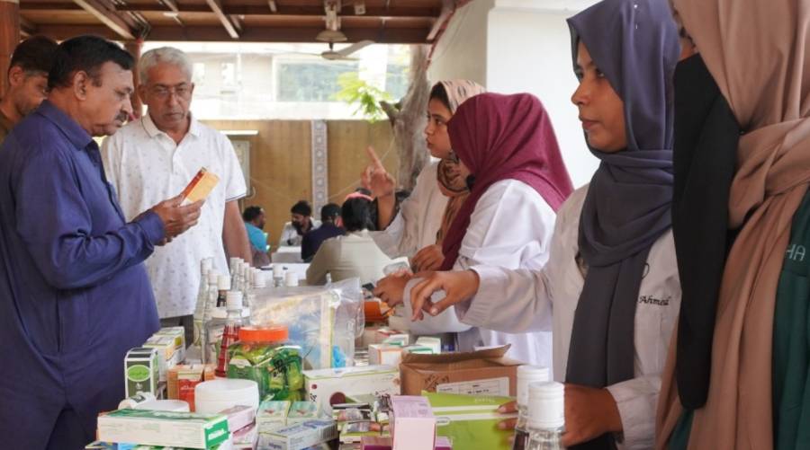 Hamdard University doctors conducting free hijama therapy and herbal medicine consultations at Karachi Press Club eastern medicine camp.