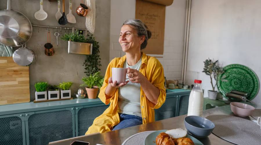 A cup of coffee, a mug of tea, and a glass of water symbolizing healthy daily drink choices linked to longevity.