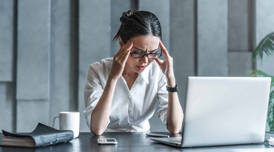 Person suffering from migraine headache caused by modern lifestyle and stress.