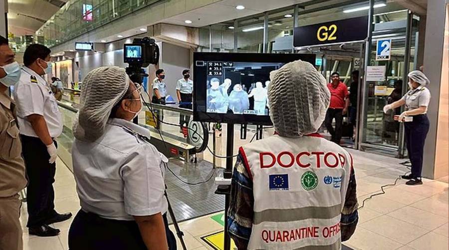 A handout photo released by Suvarnabhumi Airport shows Thai health officials wearing protective masks monitoring passengers from international flights arriving at the airport. The measures are in response to a Nipah virus outbreak in India