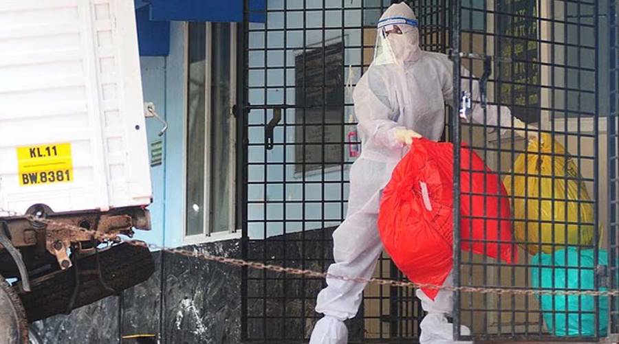A health worker is seen disposing biohazard waste from a Nipah virus isolation center at a government hospital in Kozikode, in India's southern state of Kerala, in 2023