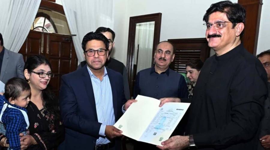 Sindh CM Murad Ali Shah presents a birth certificate to a parent during a launch of the Civil Registration Management System (CRMS) Mobile Application at CM House in Karachi on November 28.