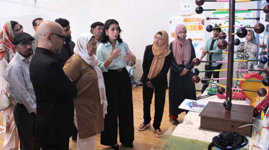 Dow College of Biotechnology students showcasing 3D science models and research posters at the 4th exhibition in Karachi.