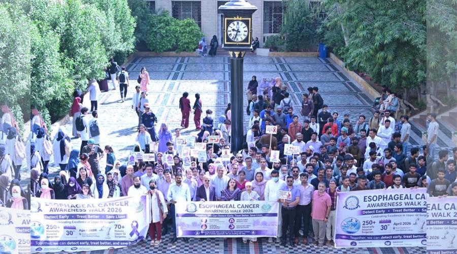 Participants standing at Clock Tower during esophageal cancer awareness walk at Dow University Karachi highlighting tobacco risks.