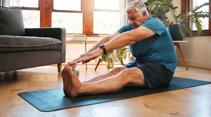 Individual lying down performing core and leg coordination exercises for balance improvement