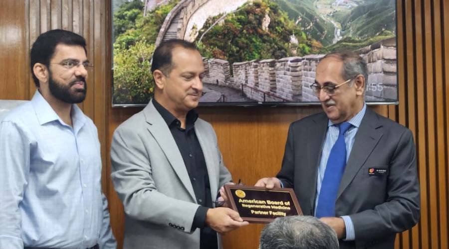 Dr. Khalid Mahmud Shah receives the official affiliate and examination center recognition certificate from Asadullah Marwat, member of the American Board of Regenerative Medicine, during a ceremony held at Al Khaleej Orthostem Clinic, Karachi. Dr. Salman Gillani is also present at the event celebrating the clinic’s international regenerative medicine milestone.