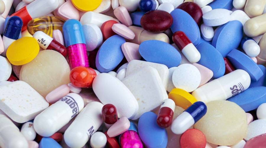 Stacks of medicines displayed at a pharmacy in Pakistan as patients face rising costs of essential drugs including insulin, antibiotics, and cardiac medicines amid inflation.