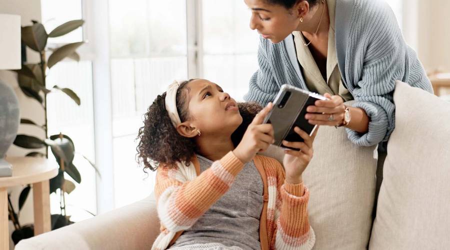 Child using a smartphone as global health leaders call for stronger digital safeguards to protect children's mental and physical wellbeing.