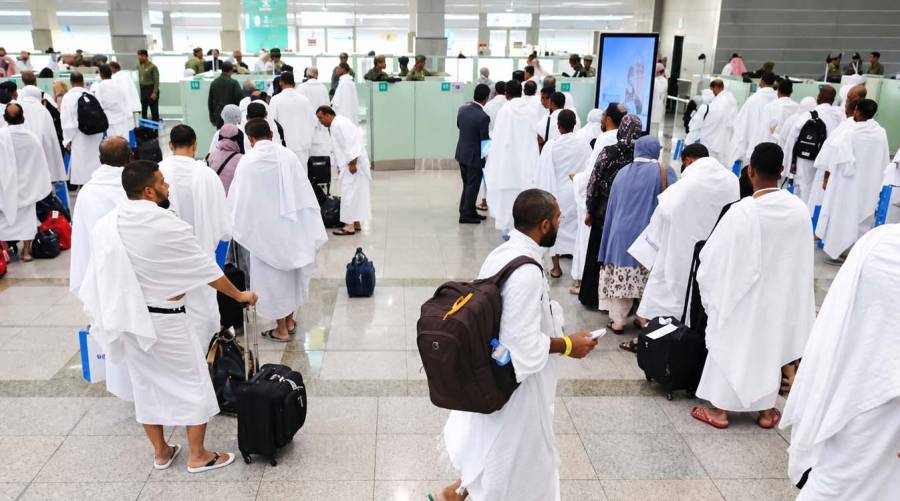 Passengers at Karachi’s Jinnah International Airport as authorities extend the deadline for Saudi-bound vaccination checks.