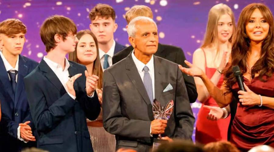 Dow Medical College alumnus Dr Asif Hasan holding his Pride of Britain Lifetime Achievement Award in a congratulatory graphic issued by Dow University of Health Sciences.